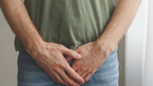 A man holding his groin to indicate a sex toy injury. 